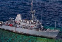 Krigsskibet USS Guardian påsejler verdensberømt filippinsk dykkerrev.